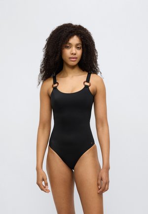 Maillot de bain une pièce noir avec des bretelles épaisses ornées d'accents ronds marron. Texture lisse et coupe taille haute. Style minimaliste.
