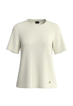 Trumpomis rankovėmis, kreminės spalvos medvilniniai marškiniai su apvalia iškirpte ir subtilaus audinio tekstūra, ant apačios krašto mažas auksinis logotipas.