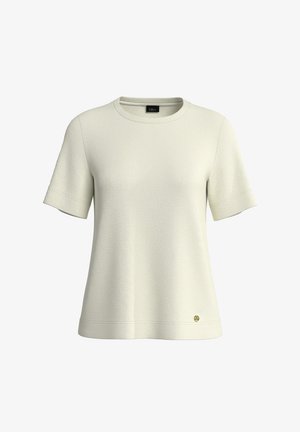 Trumpomis rankovėmis, kreminės spalvos medvilniniai marškiniai su apvalia iškirpte ir subtilaus audinio tekstūra, ant apačios krašto mažas auksinis logotipas.