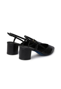 Scarpe slingback in pelle nera con punta affusolata e tacco a blocco rotondo. Presentano sottili cinturini con una fibbia tono oro. Dettaglio della soletta blu.