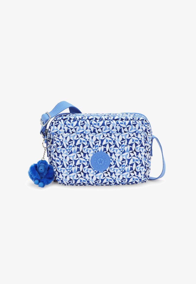 Blue patterned crossbody bag with a soft texture, featuring a blue logo, zip closure, and a blue pom-pom keychain detail.
