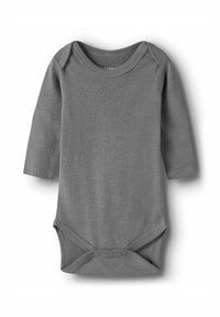 Pikkade käistega bodysuit pehmest hallist puuvillast. Omab ümarat kaelust, nööbiga alumist sulgemist ning sujuvat tekstuuri, ilma mustrite ja kaunistusteta.