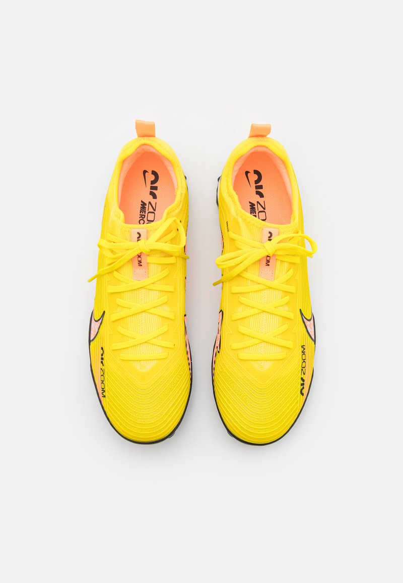 yellow nike astro turf