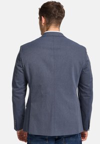 Blue blazer with a smooth texture, single vent at the back, notched lapels, and buttoned cuffs. Simple, tailored silhouette.