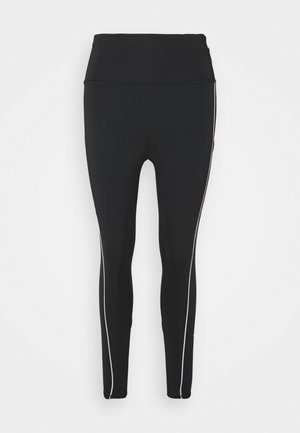 Leggings noirs avec une taille haute, fabriqués en matériau extensible, présentant des rayures latérales blanches et une texture lisse. Pas de matériel visible.