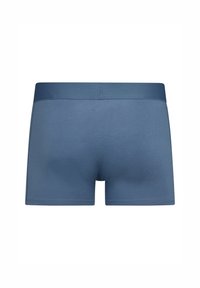 Boxers ajustados para hombre en color azul, fabricados con tejido suave, que cuentan con una cinturilla ancha y una textura lisa, con un diseño ceñido y sin patrones visibles.