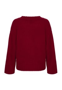 Rød strikket sweater med ribbede kanter og oversized pasform. Har en rund halsudskæring og lange ærmer med sænkede skuldre. Blød tekstur.