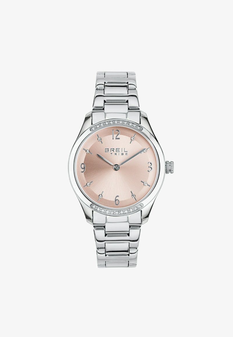 Sølv rustfrit stål ur med en pink metallisk urskive, krystalmarkeringer ved 12, 3, 6 og 9, samt en dekorativ bezel. Justerbar led-armbånd.
