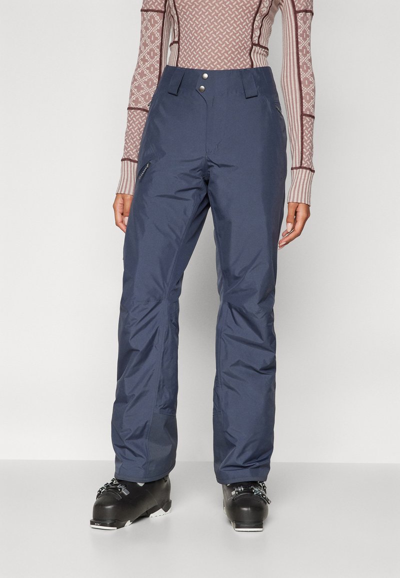 Ναυτικές παντελόνες σκι από υλικό ανθεκτικό στο νερό, με ψηλή μέση, δύο μπροστινές τσέπες με φερμουάρ και ίσια σχεδίαση για τα πόδια.