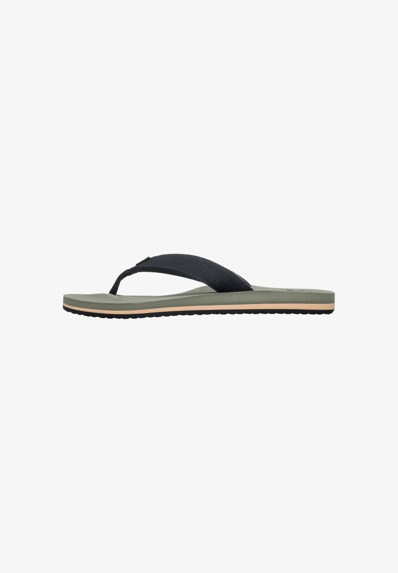 Black flip-flop sandal with a textured strap and a green sole, featuring a thin profile and a contrasting light beige accent along the edge.