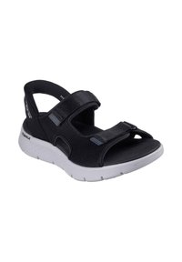 Sandalias deportivas negras con dos correas ajustables de velcro, un upper texturizado y una suela blanca acolchada para comodidad y soporte.
