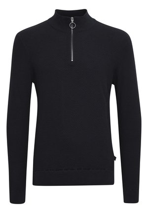 Juodas ilgomis rankovėmis polo marškinėliai su aukštu apykakle, su puse užtrauktuku ir tekstūruotu raštu. Medžiaga turi subtilų, audinį primenantį išvaizdą.