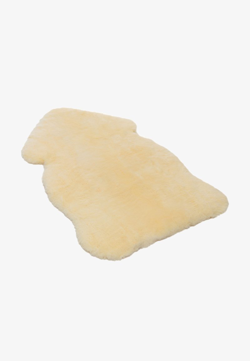 Helles beige Schaffell-Teppich mit einer weichen, flauschigen Textur, in unregelmäßiger Form und mit glatter Unterseite.