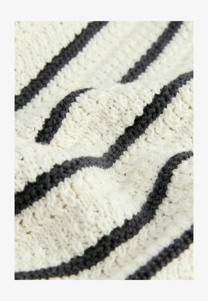 Strickdecke in Creme mit dunkelgrauen Streifen. Verfügt über ein strukturiertes Garnmuster und eine weiche, kuschelige Haptik.