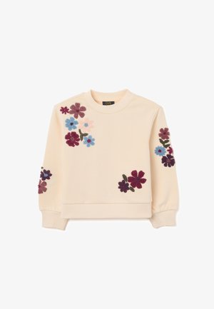 Sweatshirt beige clair avec broderies florales en rose, bleu et violet foncé. Présente des manches longues et un col rond. Texture de tissu douce.