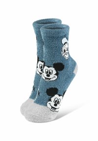 Calzini blu pelosi con volti neri di Topolino, con punta e tallone grigi. Texture morbida, altezza fino al polpaccio, design giocoso.