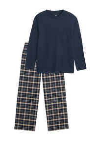 Granatowy top z długim rękawem o struktury ribbed zestawiony z spodniami w kratę w odcieniach granatu, kremu i beżu, charakteryzującymi się luźnym krojem i prostymi nogawkami.