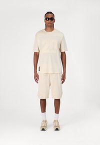 New Era Marškinėliai su spaudiniu - beige