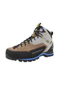 Brązowe i szare buty trekkingowe z wytrzymałą czarną podeszwą, niebieskimi akcentami, gumowym noskiem i żółtymi sznurówkami, zaprojektowane z myślą o trwałości i przyczepności.