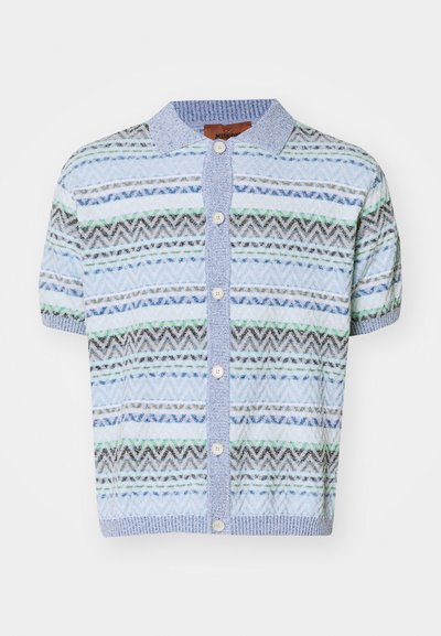 Short-sleeve button-up cardigan in light blue with an intricate zigzag pattern in darker blue, gray, and green. Finished with a ribbed collar.