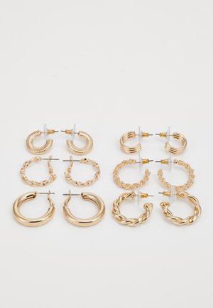 Set of six pairs of gold hoop earrings featuring varying designs: twisted, braided, and smooth surfaces, with various sizes and textures.