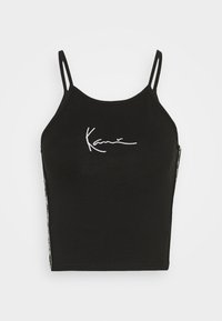 Svart avkortet tank topp med tynne stropper, med hvit brodert signatur på forsiden og et mønstrete sidepanel. Mykt bomullsmateriale.