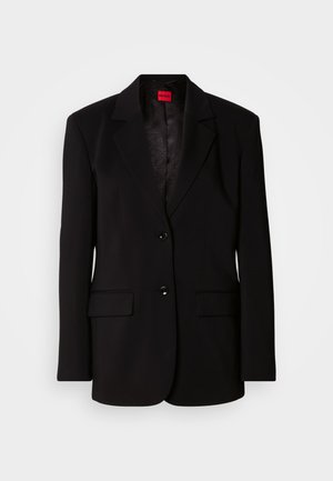 Blazer noir avec revers crantés, deux poches avant, deux boutons et une doublure intérieure à motifs. Confectionné en tissu lisse.
