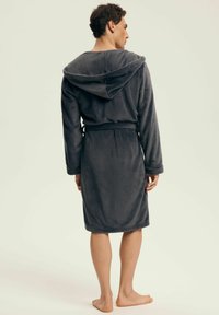 Gray, hooded bathrobe made of soft fabric, featuring a belted waist and long sleeves. The hem falls above the ankles, with no visible patterns.