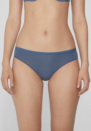 Modré bikiny kalhotky vyrobené z hladké, elastické látky. Mají tenký pás a minimalistický design. Žádné viditelné vzory nebo kovové prvky.