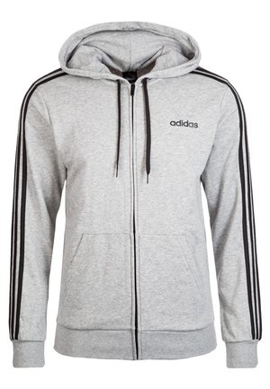 Felpa con cappuccio Adidas grigio chiaro con zip, cordini neri, tre strisce nere lungo le maniche, tasche a marsupio e piccolo logo sul petto.