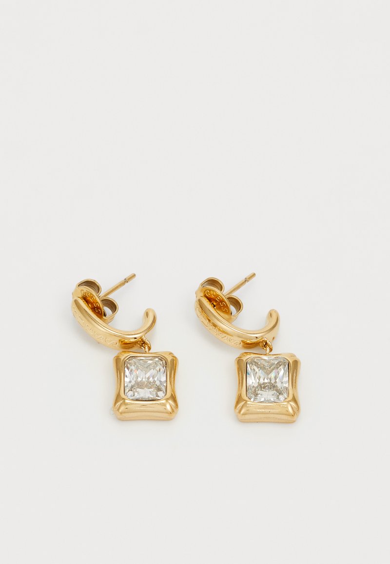 Boucles d'oreilles dorées mettant en avant des pendentifs en cristal clair en forme carrée, montés dans un cadre texturé avec un design de crochet courbé.
