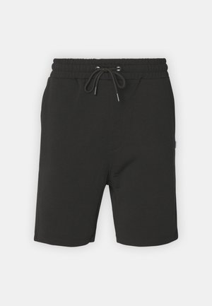 Mustat puuvillashortsit, joissa on joustava vyötärö, nyörisuljenta ja sivutaskut. Mielekäs pinta; polvipituinen malli.