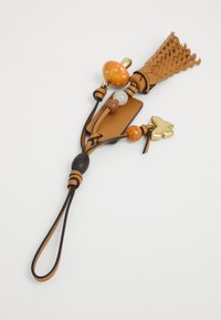 Brown leather keychain with tassel, beads in orange, white, and brown, and a small gold butterfly charm on a white background.