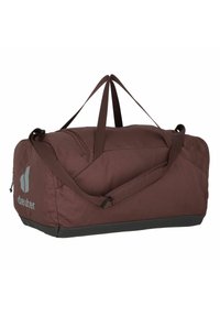 Brown fabric duffel bag with gray logo. Features double handles and a shoulder strap. Rectangular shape with a textured surface and black base.