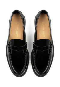 Black patent leather loafers with a low profile, round toe, decorative stitching, and a smooth finish on the upper. Leather insole details visible.
