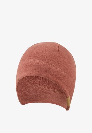 Soft textured, rust-colored knit beanie with visible stitching and a small brown fabric tag on the edge, shown on a white background.