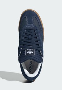 Sneaker blu navy realizzato in suede e materiale in rete, punta tonda, design lace-up, dettagli bianchi e suola in gomma color caramello.
