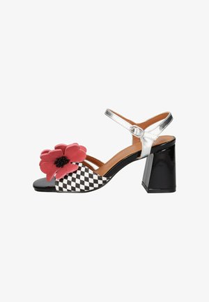 Sandalo da donna con punta aperta, parte frontale a scacchi bianco e nero, grande decorazione a fiore rosso, cinturino alla caviglia argento e tacco a blocco nero.