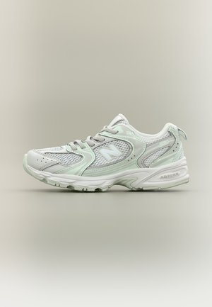 White and light gray New Balance running shoe with mesh upper, laces, and cushioned sole labeled "ABZORB," shown in side profile on neutral background.