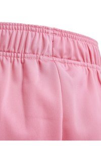 Pink elastic waistband with gathered detail, made from smooth, lightweight fabric. The material has a subtle sheen and soft texture.