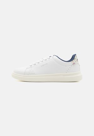 White leather sneakers with a round toe, light-colored sole, and floral accents on the heel. Features lace-up closure and perforated details.