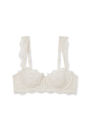 Ivoren kanten bralette met bloemmotief, met onderwire ondersteuning, brede met kant afgewerkte schouderbanden en een transparante textuur. Verstelbare sluiting aan de achterkant.