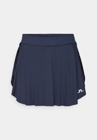 Gonna da tennis blu navy con design a pieghe, cintura elastica e dettaglio del logo sull'orlo. Realizzata in tessuto leggero e traspirante.