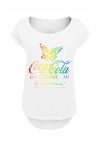 White short-sleeve T-shirt featuring a multicolored Coca-Cola logo and eagle design, with the text “You Can’t Beat The Feeling!” at the bottom.
