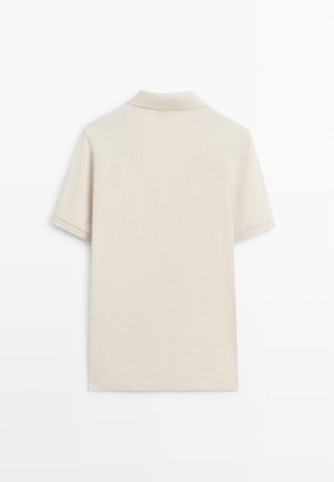 Beige short-sleeve polo shirt displayed from the back, featuring a classic collar and clean, simple design.