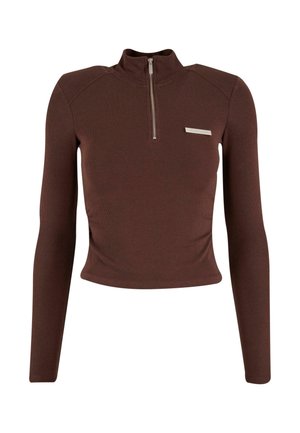 Brun ribbet langærmet top med høj krave, halv lynlås og en sølvdetalje på venstre bryst. Blød tekstur.
