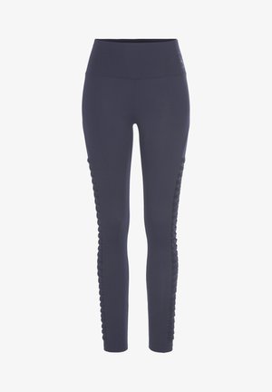 Marineblauwe leggings met een hoge tailleband, featuring textuur aan de zijkanten met een ruchesontwerp. Gemaakt van een rekbare, gladde stof.