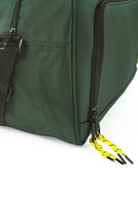 Bolso de viaje de tela texturizada verde con cremallera negra y tiradores amarillos. Presenta una forma rectangular y detalles de costura robusta.