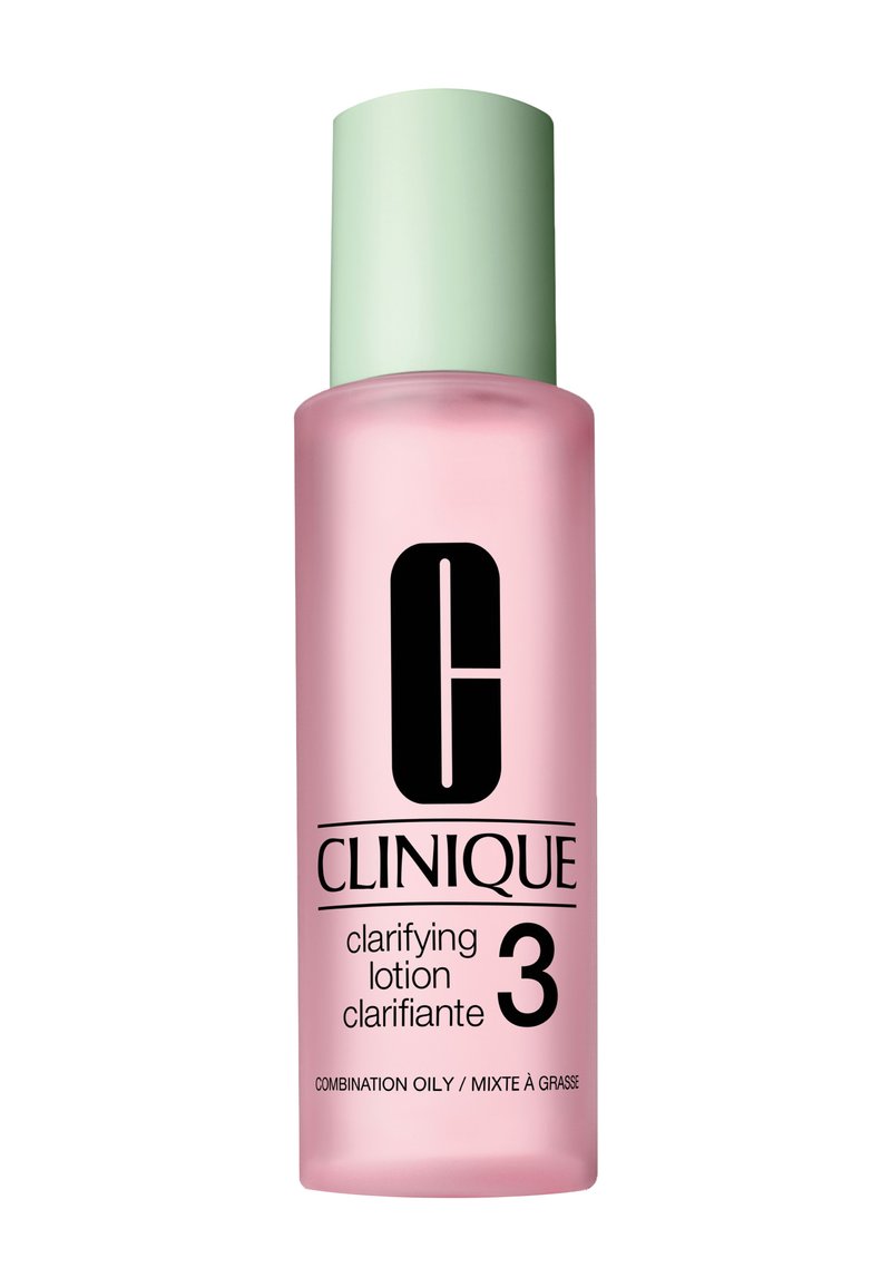 Lotion clarifiante Clinique dans un flacon en verre givré rose avec un capuchon vert clair et un texte noir, étiqueté "Peau Mixte / Mixte à Grasse."