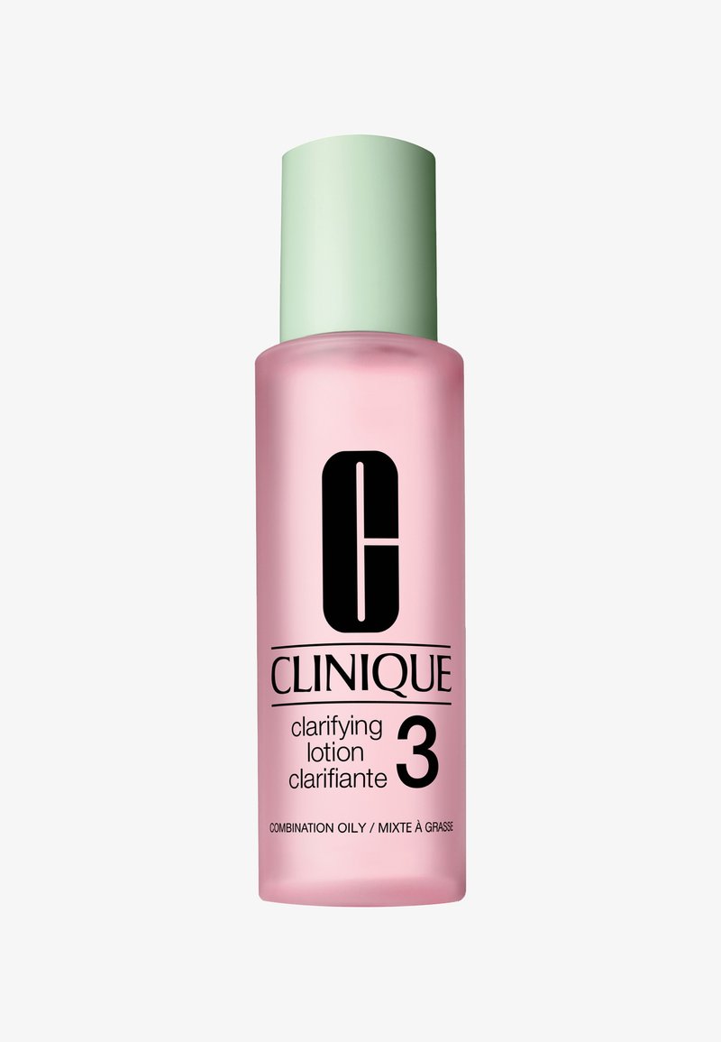 Lozione chiarificante Clinique in una bottiglia di vetro satinato rosa con un tappo verde chiaro e testo nero, etichettata "Pelle Mista / Mixte à Grasse."
